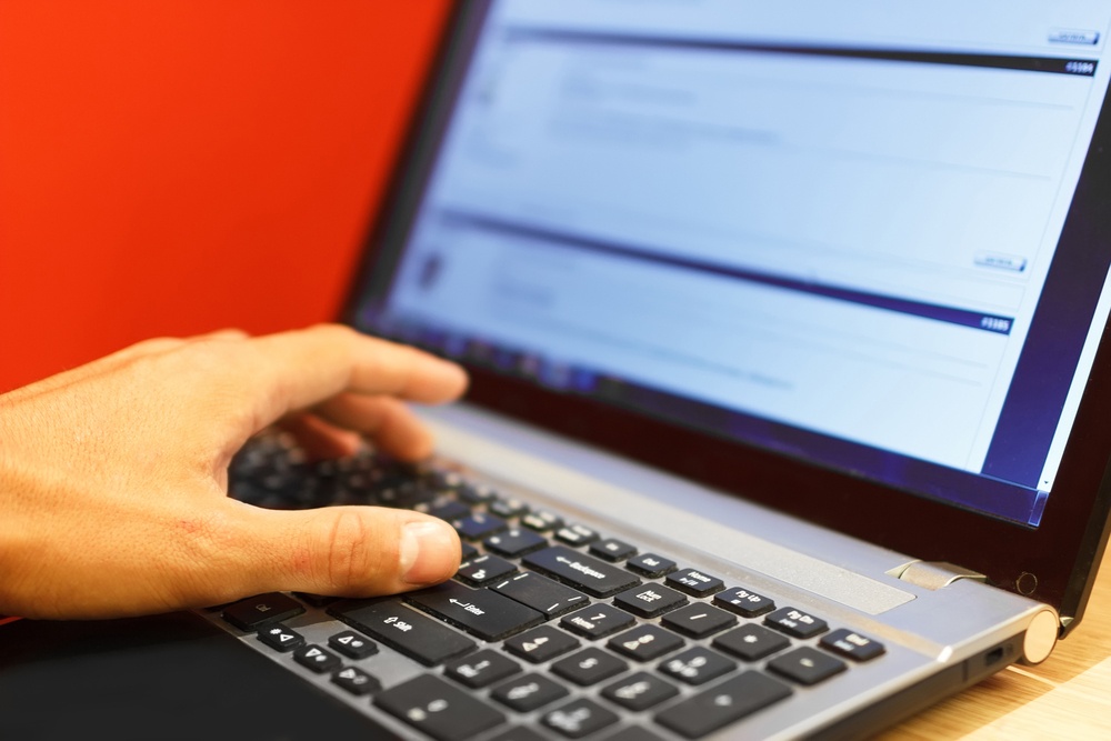 An image of hands typing on a keyboard as if a student is working on their online class